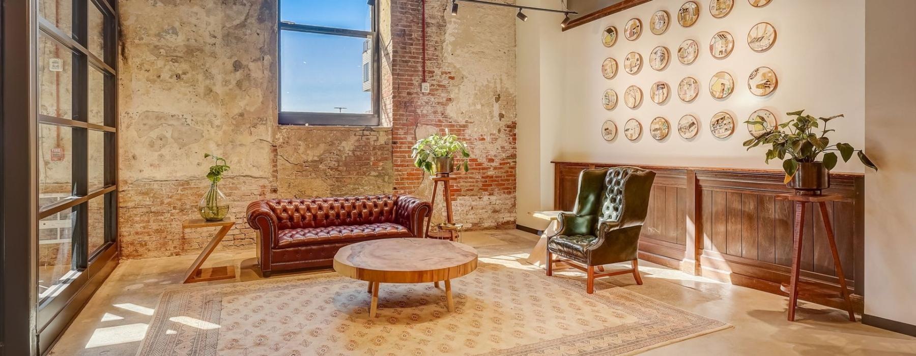 a room with a table chairs and a window