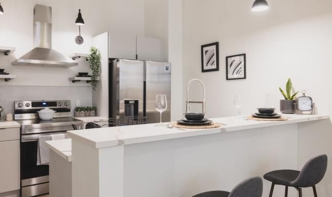 a kitchen with a white counter top