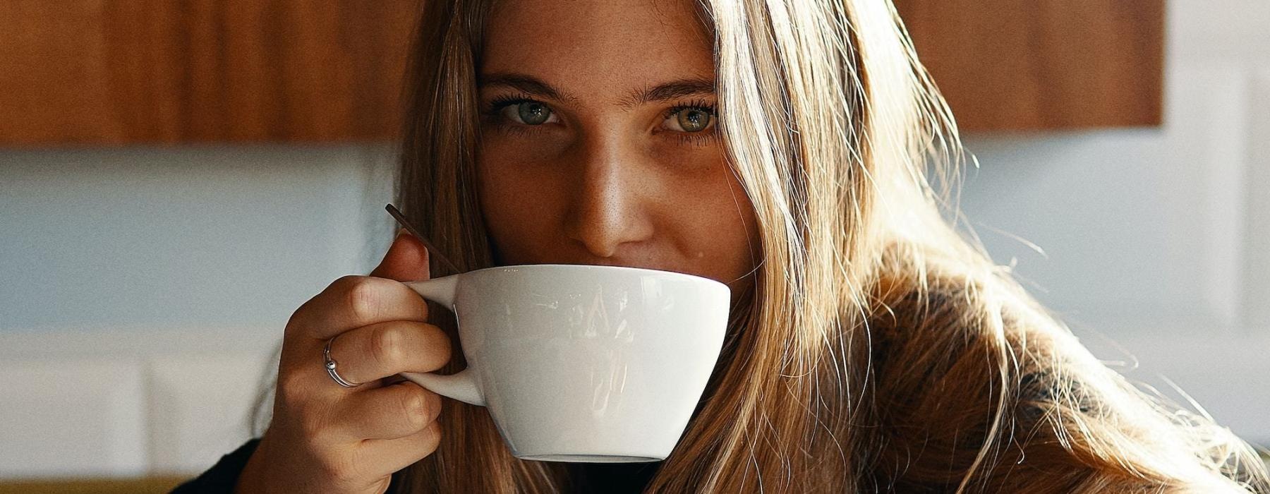 a person drinking from a cup