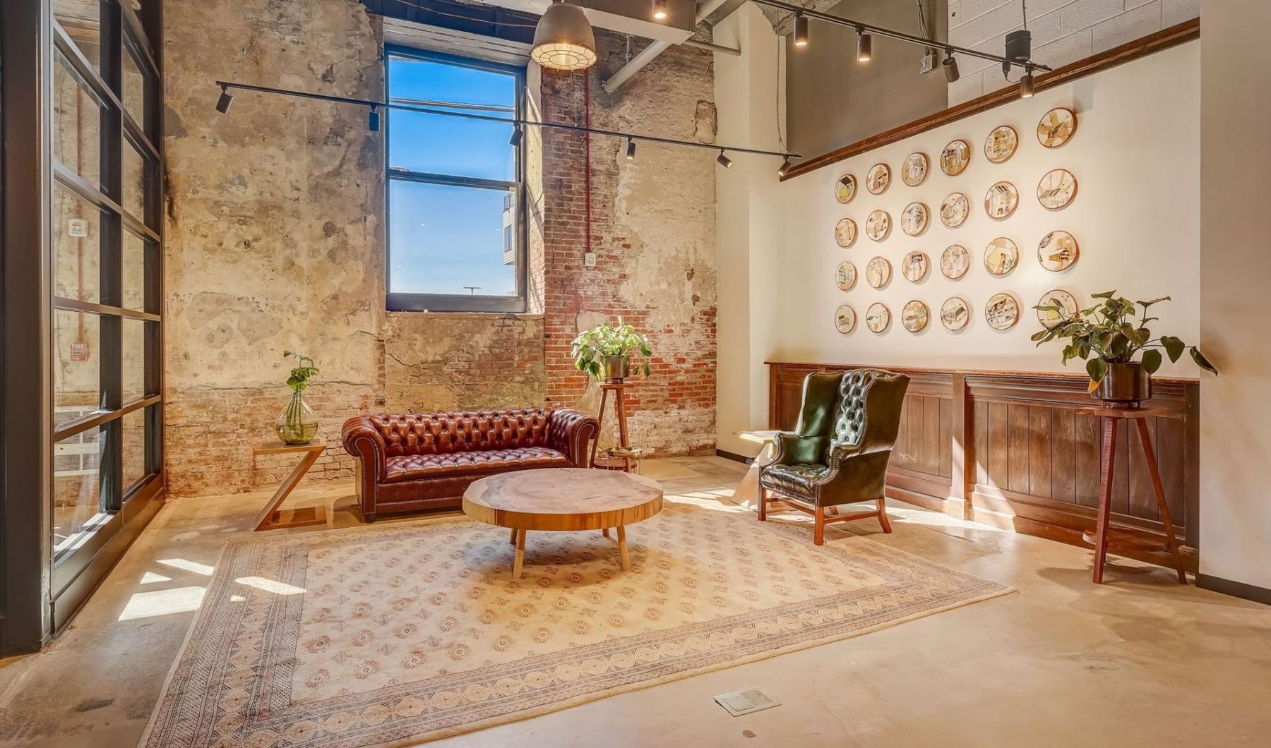 a room with a table chairs and a window