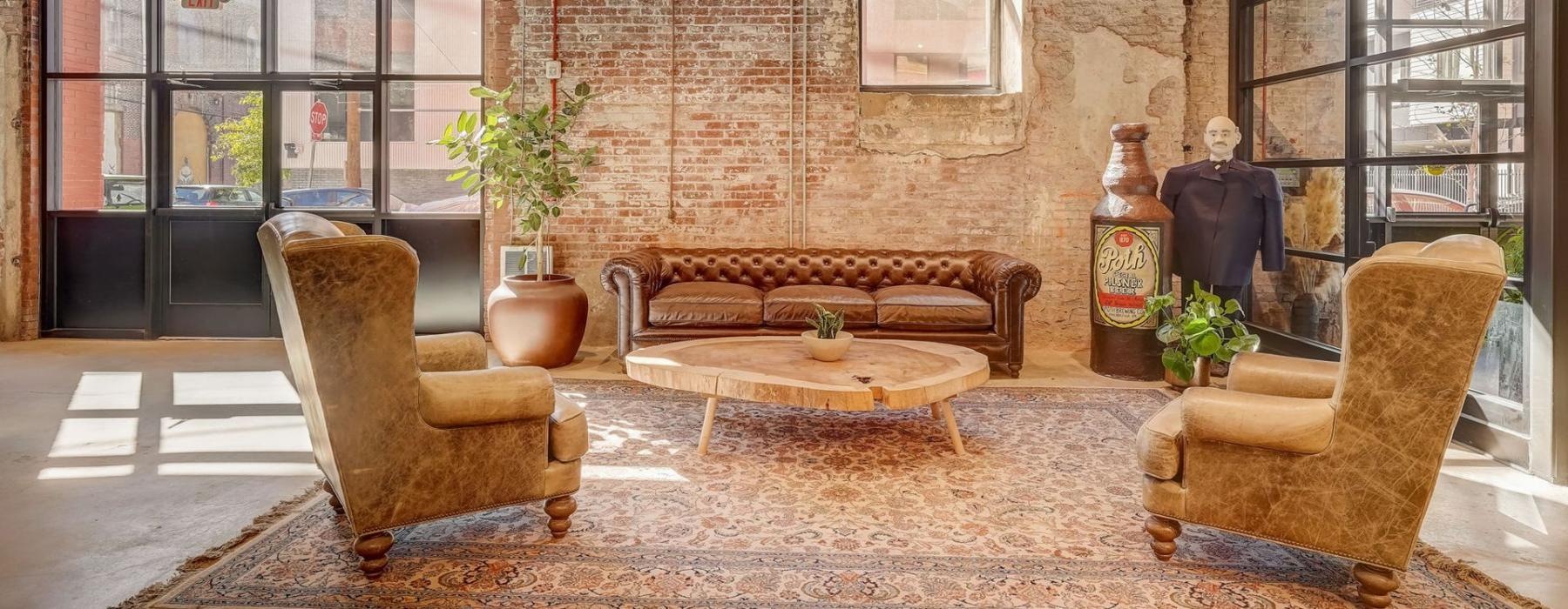a room with a couch and chairs