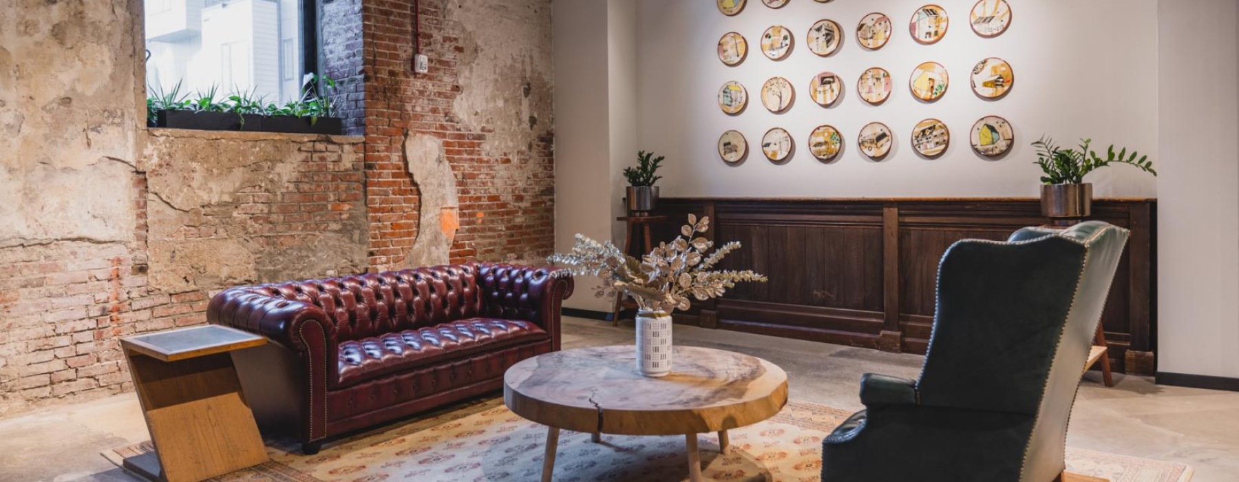 a room with a couch and chairs